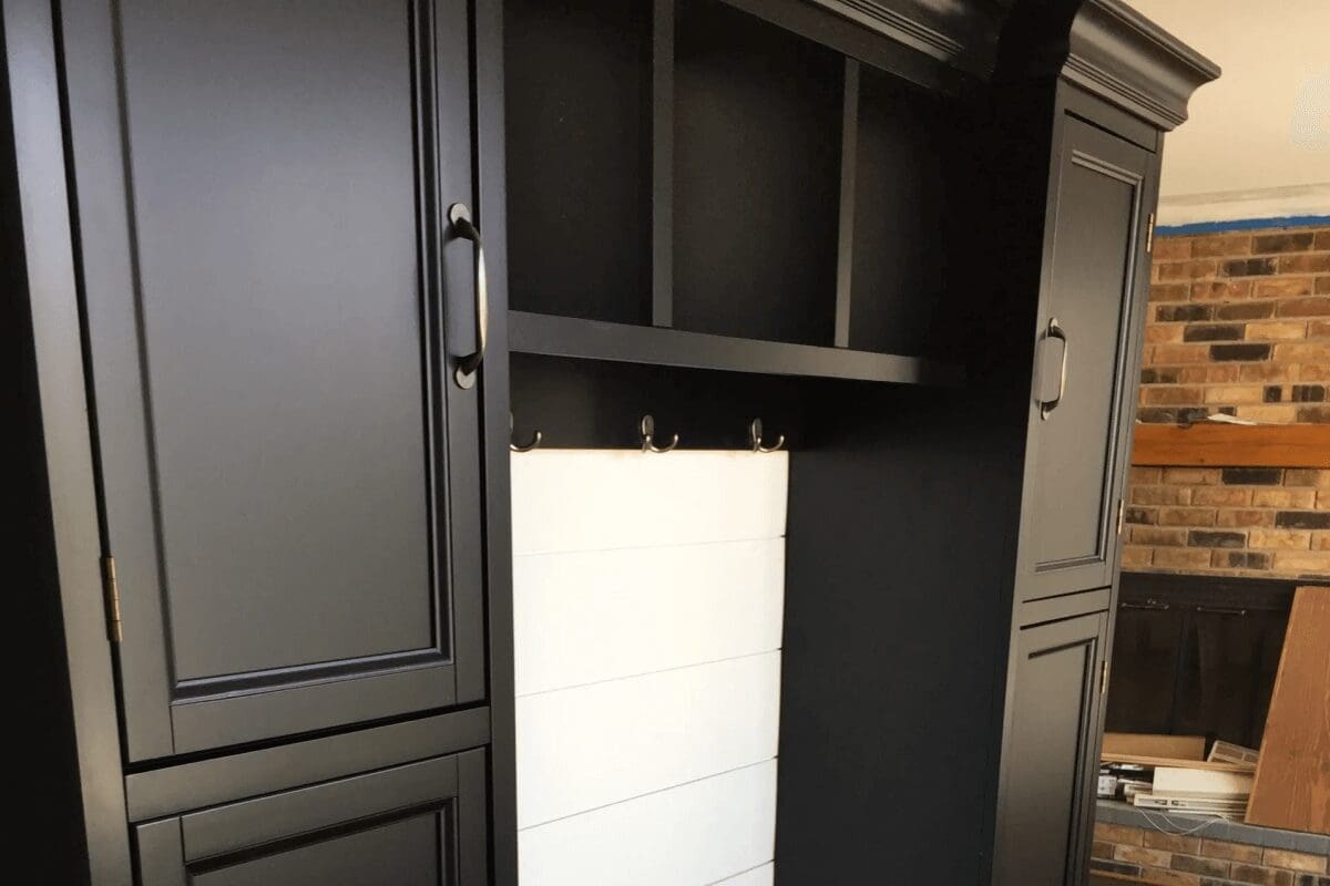 A black cabinet with a white tile floor.